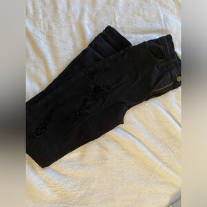 Distressed black skinny jeans